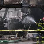 South County firefighters spray water into a business with fire damage at Plum Tree Plaza off of Highway 99 on Saturday, Sept. 11, 2021 in Edmonds, Wa. (Olivia Vanni / The Herald)