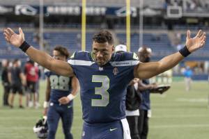 Seattle Seahawks quarterback Russell Wilson gestures as he walks off the field after an NFL preseason football game against the Los Angeles Chargers, Saturday, Aug. 28, 2021, in Seattle. The Seahawks won 27-0. (AP Photo/Stephen Brashear)