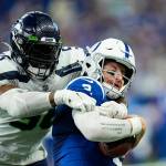 Seattle Seahawks linebacker Jordyn Brooks (56) sacks Indianapolis Colts quarterback Carson Wentz during the second half of a game in Indianapolis on Sunday. (AP Photo/AJ Mast)