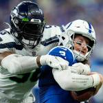Seattle Seahawks linebacker Jordyn Brooks (56) sacks Indianapolis Colts quarterback Carson Wentz (2) during the second half of an NFL football game in Indianapolis, Sunday, Sept. 12, 2021. (AP Photo/AJ Mast)