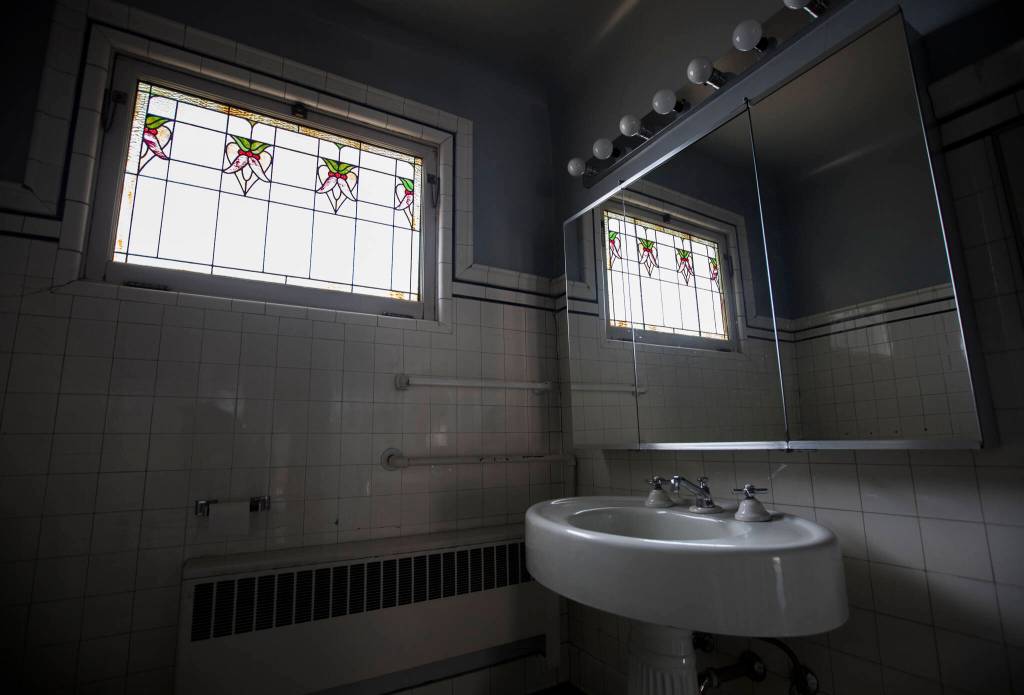 Stained glass panels inside the second-floor bathroom of the Van Valey House on Wednesday in Everett. (Olivia Vanni / The Herald)