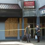 Mark Choi, right, and an employee leave his office in the Plum Tree Plaza, after firefighters check for hot spots from Saturday's fire, on Monday, Sept. 13, 2021 in Edmonds, Washington.  (Andy Bronson / The Herald)
