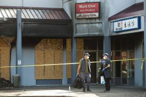 Mark Choi, right, and an employee leave his office in the Plum Tree Plaza, after firefighters check for hot spots from Saturday's fire, on Monday, Sept. 13, 2021 in Edmonds, Washington.  (Andy Bronson / The Herald)
