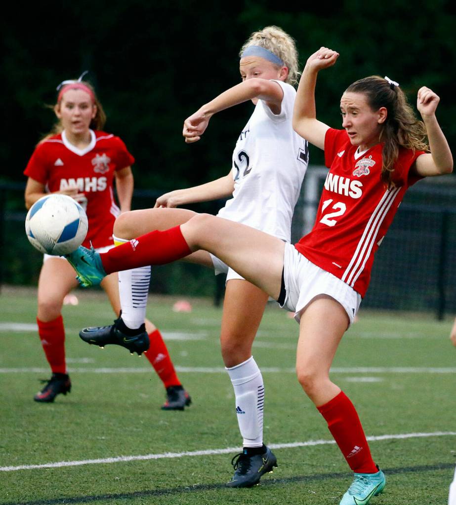 Arlingtons Carly Bartlow, left, and Archbishop Murphys Lilia Echols vie the ball at Archbishop Murphy High School Tuesday night in Everett on September 14, 2021. The Wildcats won 6-1. (Kevin Clark / The Herald)