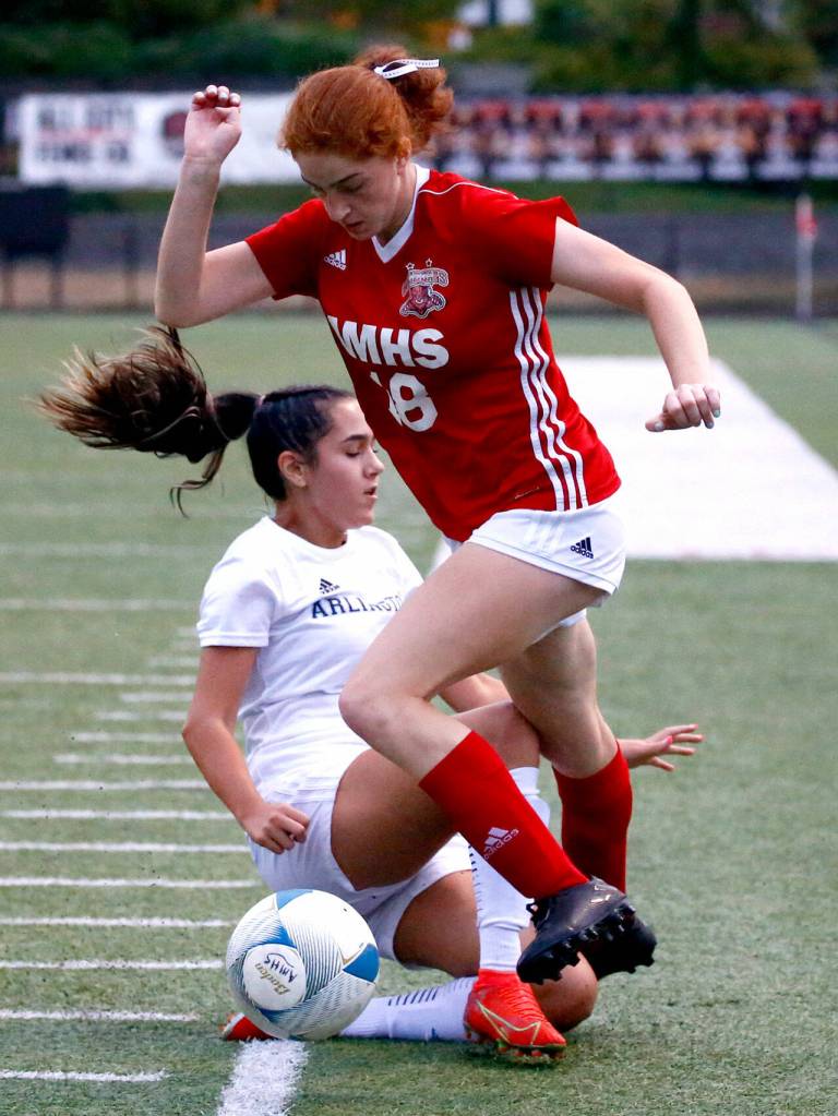 Archbishop Murphys Brie Cote avoids a tackle by Arlingtons Maddy Stivers at Archbishop Murphy High School Tuesday night in Everett on September 14, 2021. The Wildcats won 6-1. (Kevin Clark / The Herald)