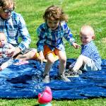 Erik Denton (left) holds his youngest daughter, Sierra, while his daughter Joanna chases bubbles and son Terry watches. Denton's three kids were killed in April. (Contributed)