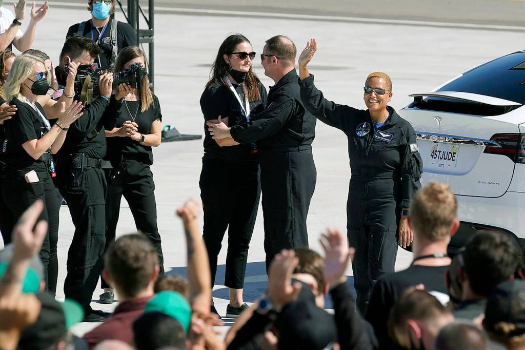 Inspiration4 crew member Dr. Sian Proctor (right) waves to family members as Chris Sembroski talks to a family member before a trip to Kennedy Space Centers Launch Pad 39-A and a planned liftoff on a SpaceX Falcon 9 rocket Wednesday in Cape Canaveral, Florida. (AP Photo/John Raoux)