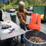 Tony Thompson, operations coordinator with The Hand Up Project, dumps collected needles into a trash bin Sunday near Everett. (Olivia Vanni / The Herald)