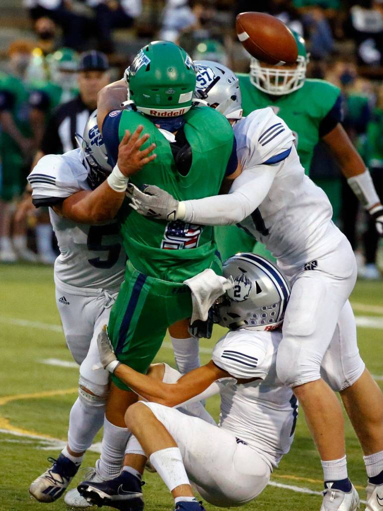 Glacier Peaks defense pressures Woodinvilles Theo Grothen forcing an incomplete pass Thursday evening at Pop Keeney Stadium in Bothell on September 16, 2021. (Kevin Clark / The Herald)