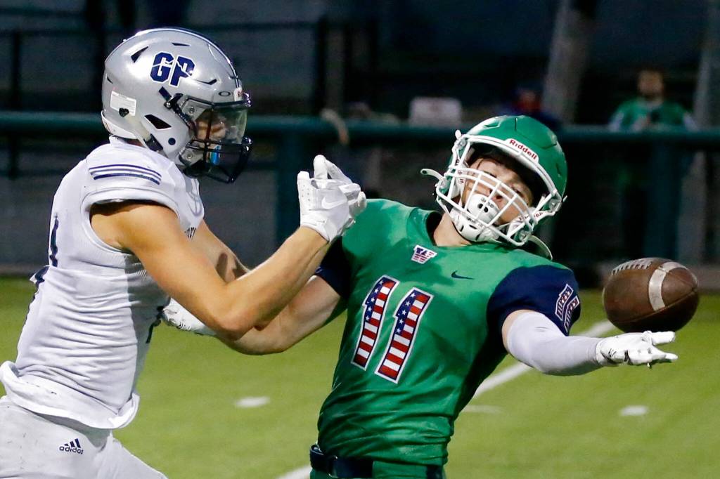 Woodinvilles Nick Owens, right, breaks up a pass intended for Glacier Peaks Jadon Claps Thursday evening at Pop Keeney Stadium in Bothell on September 16, 2021. (Kevin Clark / The Herald)