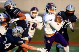 Lake Stevens' Bryce Moser rushes for yardage against Glacier Peak Thursday night at Veterans Memorial Stadium in Snohomish on April 1, 2021. (Kevin Clark / The Herald)