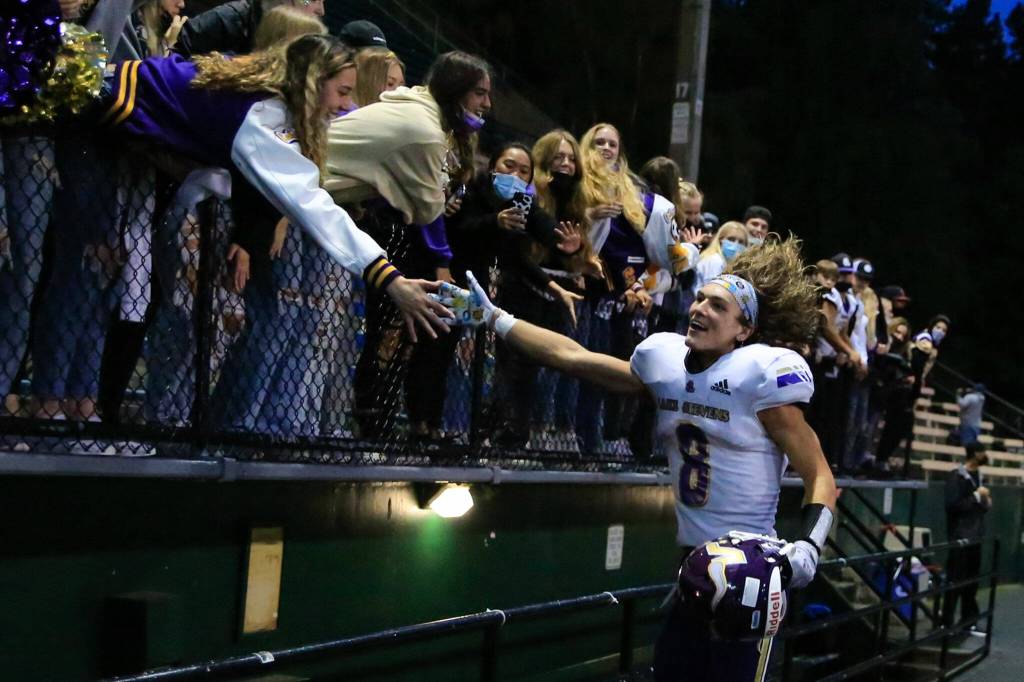 Lake Stevens Drew Carter celebrates with the fans Friday at Memorial Stadium in Seattle on September 17, 2021. The Vikings defeated the Irish, 20-3. (Kevin Clark / The Herald)