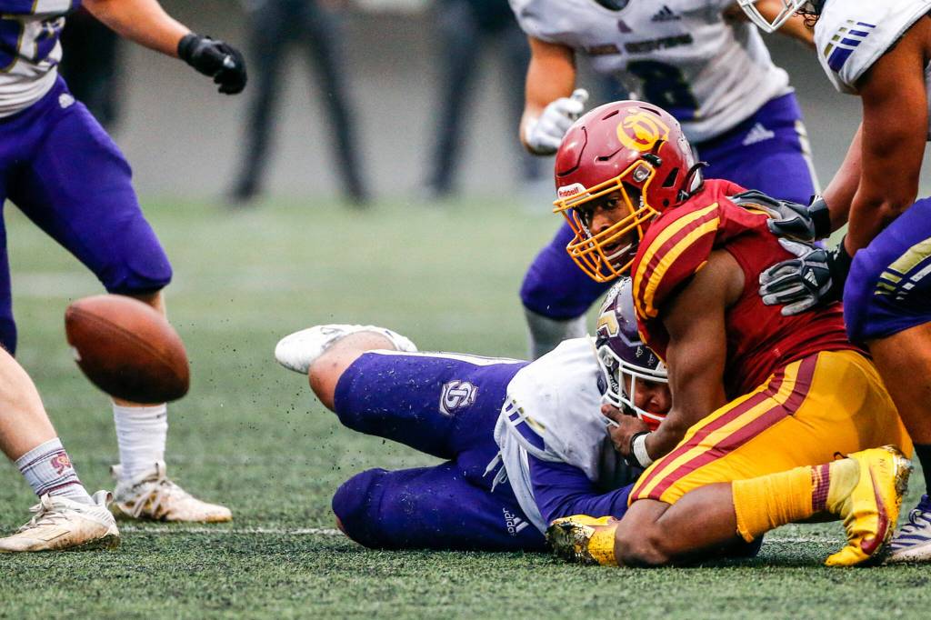 Lake Stevens Madison Wynkoop forces a fumble by ODea star running back Jason Brown. The Vikings held the Fighting Irishs high-powered rushing attack to just three points. (Kevin Clark / The Herald)