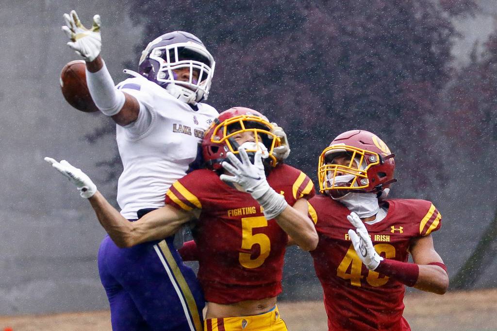 Lake Stevens Traycee Hanks breaks up a pass intended for ODeas Joe Gallagher, center or Sejhe Jackson Friday at Memorial Stadium in Seattle on September 17, 2021. The Vikings defeated the Irish, 20-3. (Kevin Clark / The Herald)