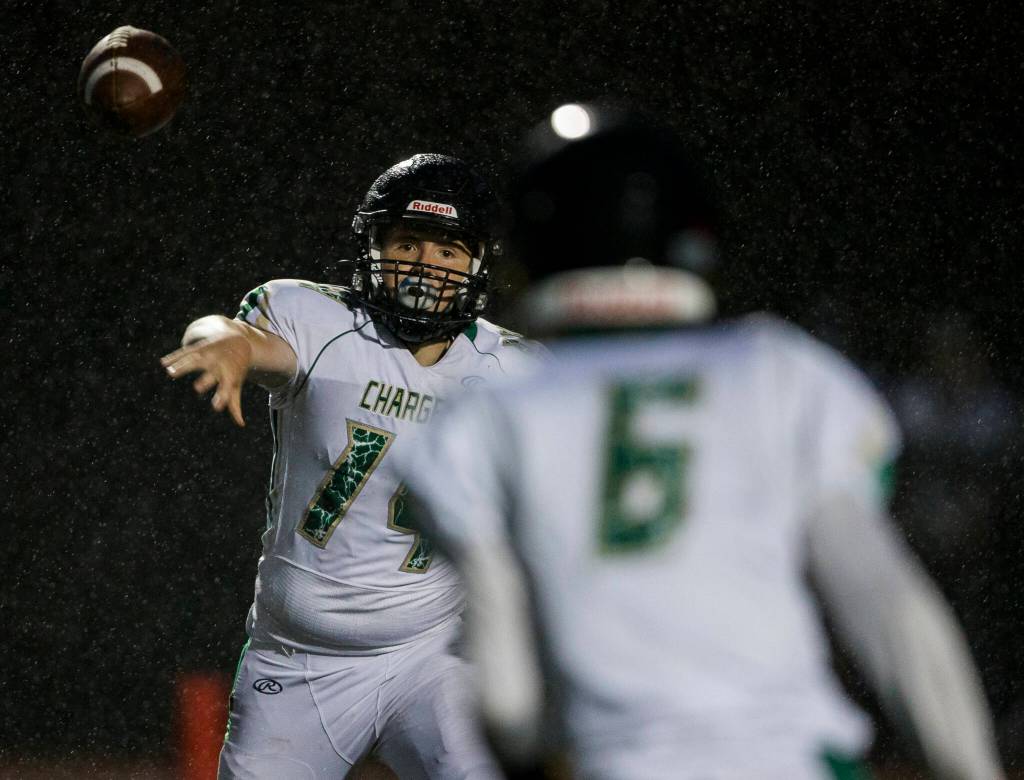 Marysville Getchells Logan Maddock passes the ball to Carter Schmidt during the annual Berry Bowl on Friday, Sept. 17, 2021 in Marysville, Wa. (Olivia Vanni / The Herald)