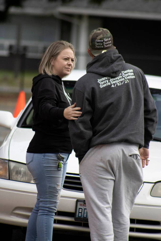 Friends comforted Erik Denton during a toy drive honoring the loss of his three children. (Isabella Breda / The Herald)