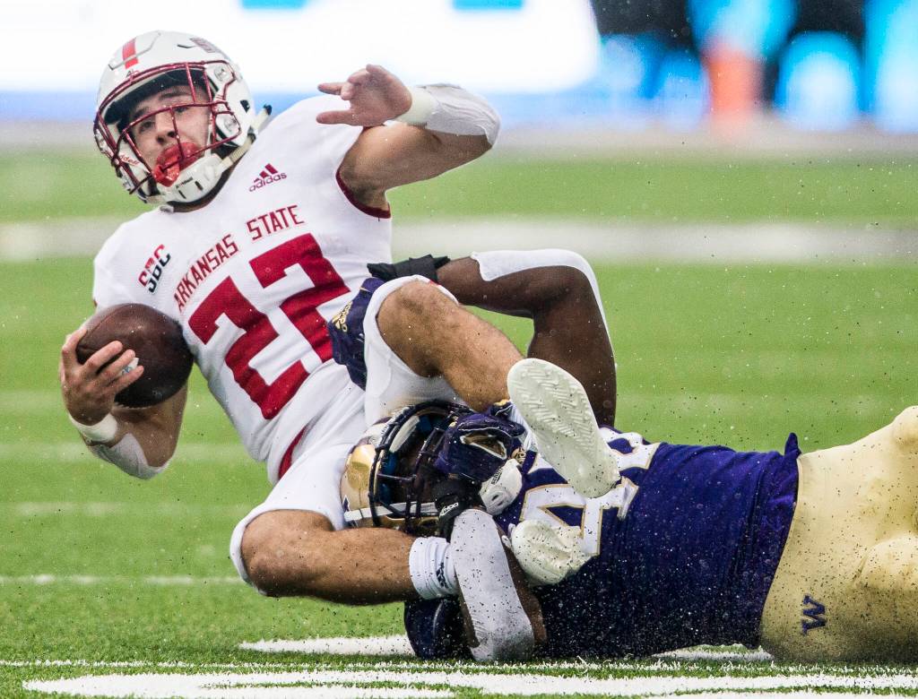 Arkansas States Lincoln Pare is tackled during the game on Saturday, Sept. 18, 2021 in Seattle, Wa. (Olivia Vanni / The Herald)
