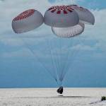 In this image taken provided by SpaceX, a capsule carrying four people parachutes into the Atlantic Ocean off the Florida coast, Saturday, Sept. 18, 2021. The all-amateur crew was the first to circle the world without a professional astronaut.  (SpaceX via AP)