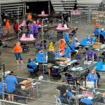 In this May 6 photo, Maricopa County ballots cast in the 2020 general election are examined and recounted by contractors working for Florida-based company Cyber Ninjas at Veterans Memorial Coliseum in Phoenix. (AP Photo/Matt York, Pool, File)