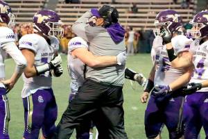 Lake Stevens' Tom Tri celebrates with his team in the during a timeout Friday at Memorial Stadium in Seattle on September 17, 2021. The Vikings defeated the Irish, 20-3. (Kevin Clark / The Herald)