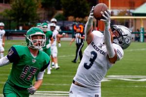 Glacier Peak's Ashton Olson makes a touchdown reception with Woodinville's Jeffrey Perran trailing Thursday evening at Pop Keeney Stadium in Bothell on September 16, 2021. (Kevin Clark / The Herald)