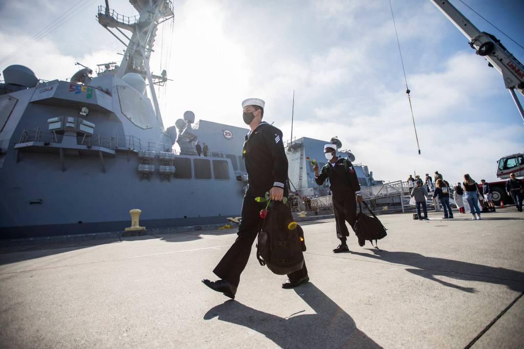 Sailors disembark the USS Kidd after returning from deployment on Friday in Everett. (Olivia Vanni / The Herald)