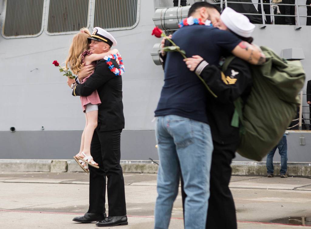 Shane Freeman hugs his daughter, Elizabeth Freeman, 5, after his returns from deployment aboard the USS Kidd on Friday in Everett. (Olivia Vanni / The Herald)