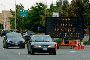 A sign directs motorists to a COVID-19 testing site, Wednesday, Sept. 22, 2021, in Tukwila, Wash., south of Seattle. (AP Photo/Ted S. Warren)