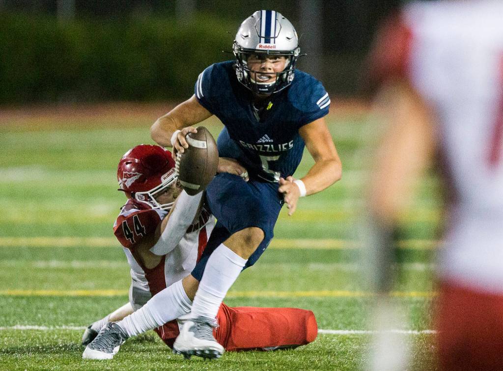 Christain Van Natta and Marysville Pilchucks defensive front provided relentless pressure on Glacier Peak quarterback River Lien. (Olivia Vanni / The Herald)
