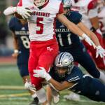 Marysville Pilchucks Dylan Carson is tackled by Glacier Peaks Reggie Valmonte during a game on Friday in Snohomish. (Olivia Vanni / The Herald)