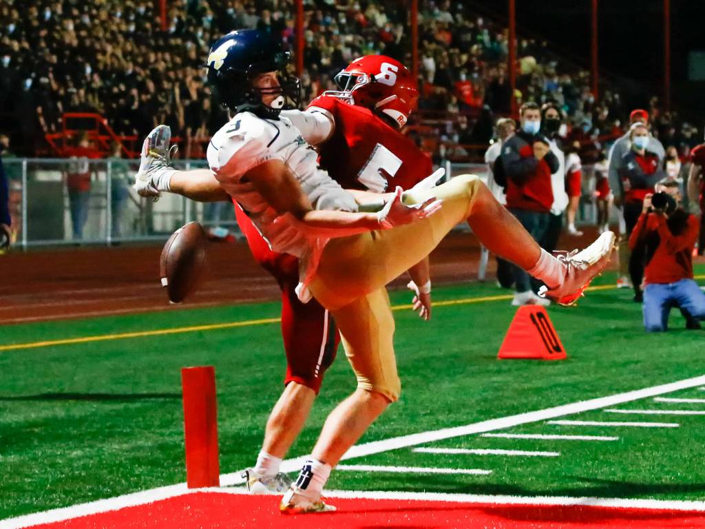 Stanwoods Ryder Bumgarner breaks up a pass intended for Arlingtons Gage Price during the Stilly Cup on Friday night at Stanwood High School. (Kevin Clark / The Herald)
