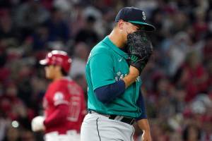 Seattle Mariners relief pitcher Justus Sheffield, right, yells into his glove after walking in a run as Los Angeles Angels designated hitter Shohei Ohtani advances to third during the fifth inning of a baseball game Saturday, Sept. 25, 2021, in Anaheim, Calif. (AP Photo/Mark J. Terrill)