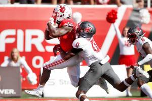 Utah running back TJ Pledger (5) runs for a touchdown as Washington State defensive back Jaylen Watson (0) tries to tackle him in the second half, of an NCAA college football game Saturday, Sept. 25, 2021, in Salt Lake City. (AP Photo/George Frey)