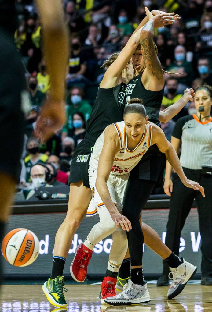 Phoenix Mercurys Diana Taurasi is double teamed by Seattles Stephanie Talbot and Mercedes Russell during the second-round, single elimination playoff game at Angel of the Winds Arena on Sunday in Everett. (Olivia Vanni / The Herald)