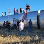 People work at the scene of an Amtrak train derailment on Saturday in north-central Montana. Three people were killed, the train agency said. (Kimberly Fossen / via Associated Press)