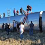 In this photo provided by Kimberly Fossen people work at the scene of an Amtrak train derailment on Saturday, Sept. 25, 2021, in north-central Montana. Multiple people were injured when the train that runs between Seattle and Chicago derailed Saturday, the train agency said. (Kimberly Fossen via AP)