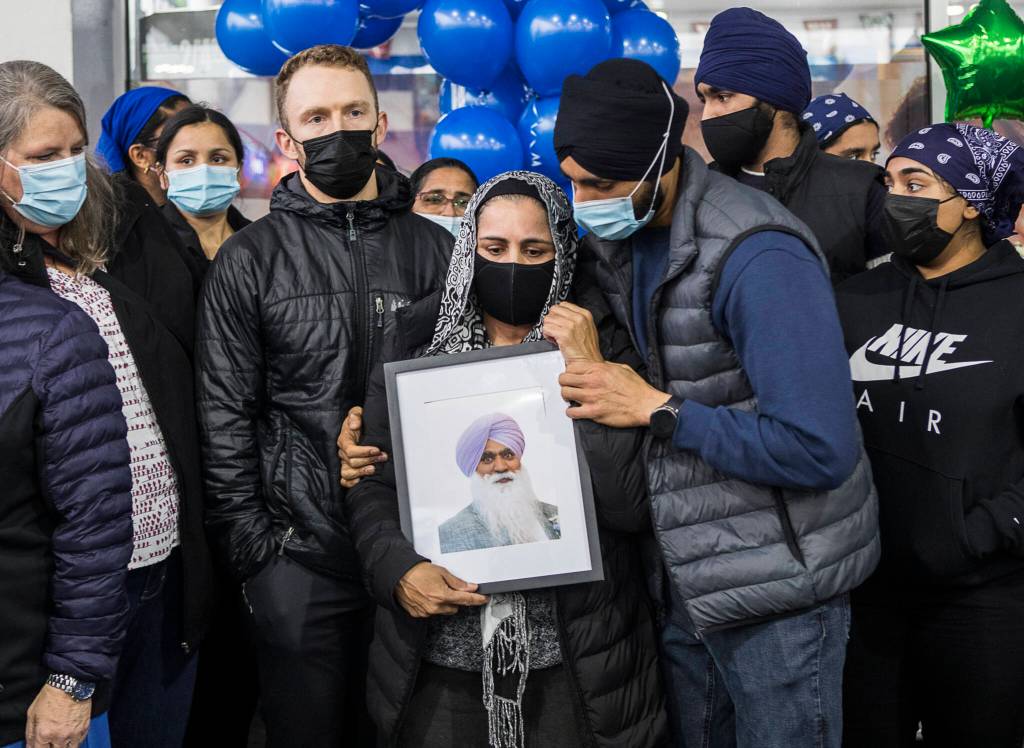 Jaswant Singh holds a photograph of her husband TejPal Singh at his candlelight vigil on Wednesday, Sept. 29, 2021 in Lynnwood, Wa. (Olivia Vanni / The Herald)