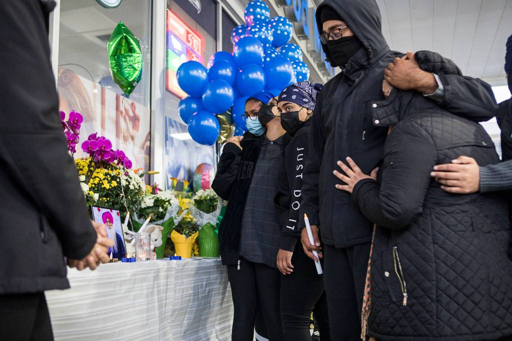 TejPal Singhs children and family members approach a small memorial table set up at his candlelight vigil on Wednesday, Sept. 29, 2021 in Lynnwood, Wa. (Olivia Vanni / The Herald)