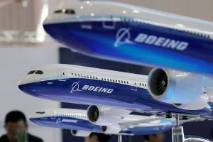 FILE- In this Nov. 6, 2018, file photo, models of Boeing passenger airliners are displayed during the Airshow China in Zhuhai city, south China's Guangdong province. China’s airline industry association has thrown its support behind 13 Chinese carriers seeking compensation from Boeing for groundings of the 737 Max 8. (AP Photo/Kin Cheung, File)