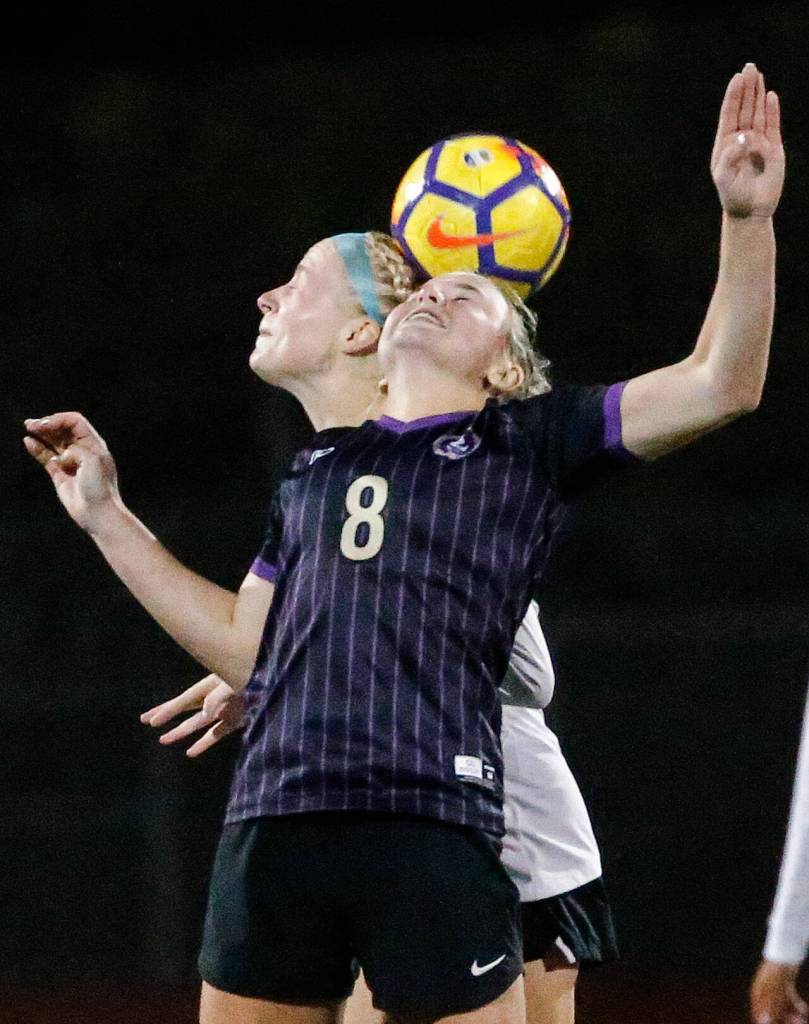 Lake Stevens Zoe Hopkins, front, and Jacksons Kate Russell jump for a header Tuesday night at Lake Stevens High School on September 28, 2021. (Kevin Clark / The Herald)