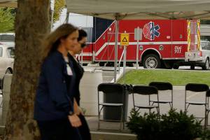 Workers walk in front of Kootenai Health, Friday, Sept. 10, 2021, in Coeur d'Alene, Idaho. (AP Photo/Young Kwak)