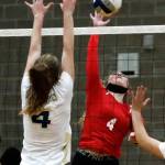 Arlingtons Malia Shepherd jumps to block Snohomishs Mikala Milburn Wednesday night at Arlington High School on September 29, 2021. The Eagles won in straight sets. (Kevin Clark / The Herald)