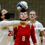 Snohomishs Lauren Ellis volleys with teammate Reagan Bullock looking on Wednesday night at Arlington High School on September 29, 2021. The Eagles won in straight sets. (Kevin Clark / The Herald)