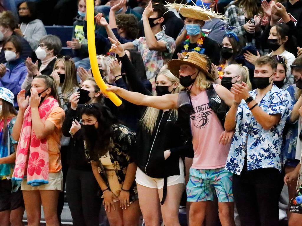 Arlingtons fans cheer a point against Snohomish Wednesday night at Arlington High School on September 29, 2021. The Eagles won in straight sets. (Kevin Clark / The Herald)