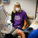 Deena Jones (left) gets her vitals measured by Daniel Johnson during one of her twice weekly checkups at UW Medicine in Seattle on Sept. 30. (Kevin Clark / The Herald)