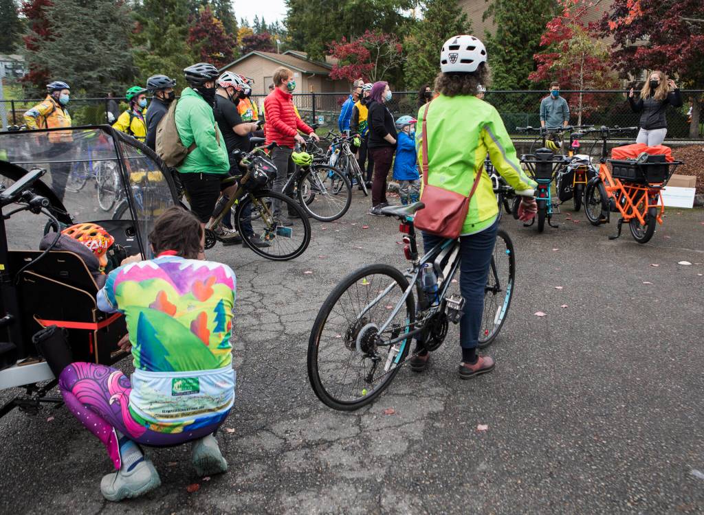 A few dozen people gather before the start of the Leafline Trail Coalition and Snohomish County Transportation Coalition &ldquo;policy ride&rdquo; on Saturday in Mountlake Terrace. (Olivia Vanni / The Herald)
