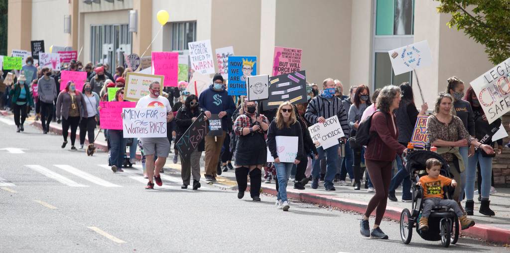 Several hundred activists march in support of reproductive rights on Saturday, Oct. 2, 2021 in Everett, Washington. (Andy Bronson / The Herald)