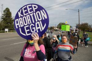 Several hundred activists march in support of reproductive rights on Saturday, Oct. 2, 2021 in Everett, Washington. The march started at Everett Mall and then along Highway 99. (Andy Bronson / The Herald)