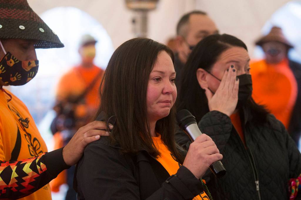Rochelle Lubbers (center) tears up as she talks about putting her native identity aside while attending school as she and the Tulalip Tribes community gathered at the last remaining building from the Tulalip Indian boarding school for a Day of Remembrance on Thursday in Tulalip Reservation. (Andy Bronson / The Herald)