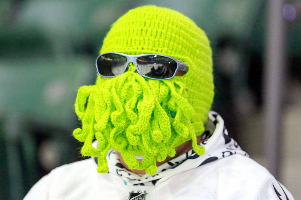 A fan wears a knitted Kraken on his head at the Angel of the Winds Arena in Everett. (Kevin Clark / The Herald)
